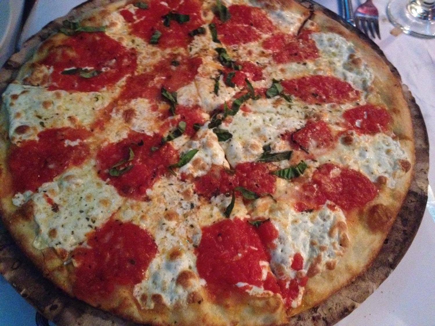 Margherita pizza with basil and melted mozzarella