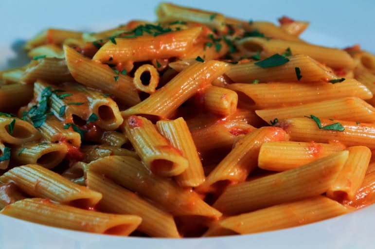 A bowl of pasta in tomato sauce